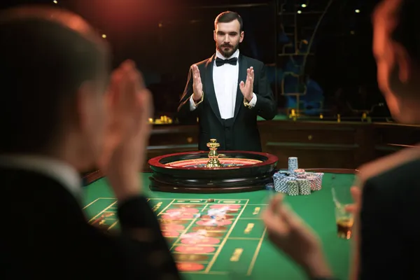 A glamorous woman holding casino chips in a neon-lit environment, representing the premium online casino atmosphere of BIGPARI.